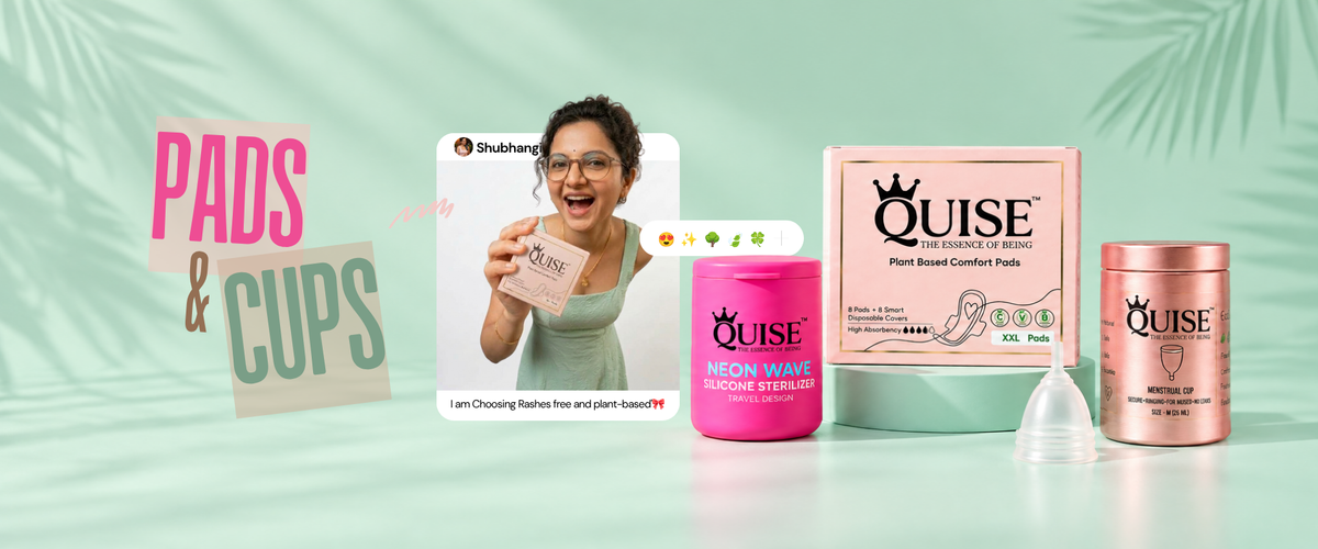 A promotional product display for OUISE pads and cups, featuring a woman holding a pink pad pack, a pink neon wax insert pack, a pink box, a pink cup, and a clear cup, arranged on a mint green background with tropical leaf silhouettes and large 'PADS & CUPS' text.